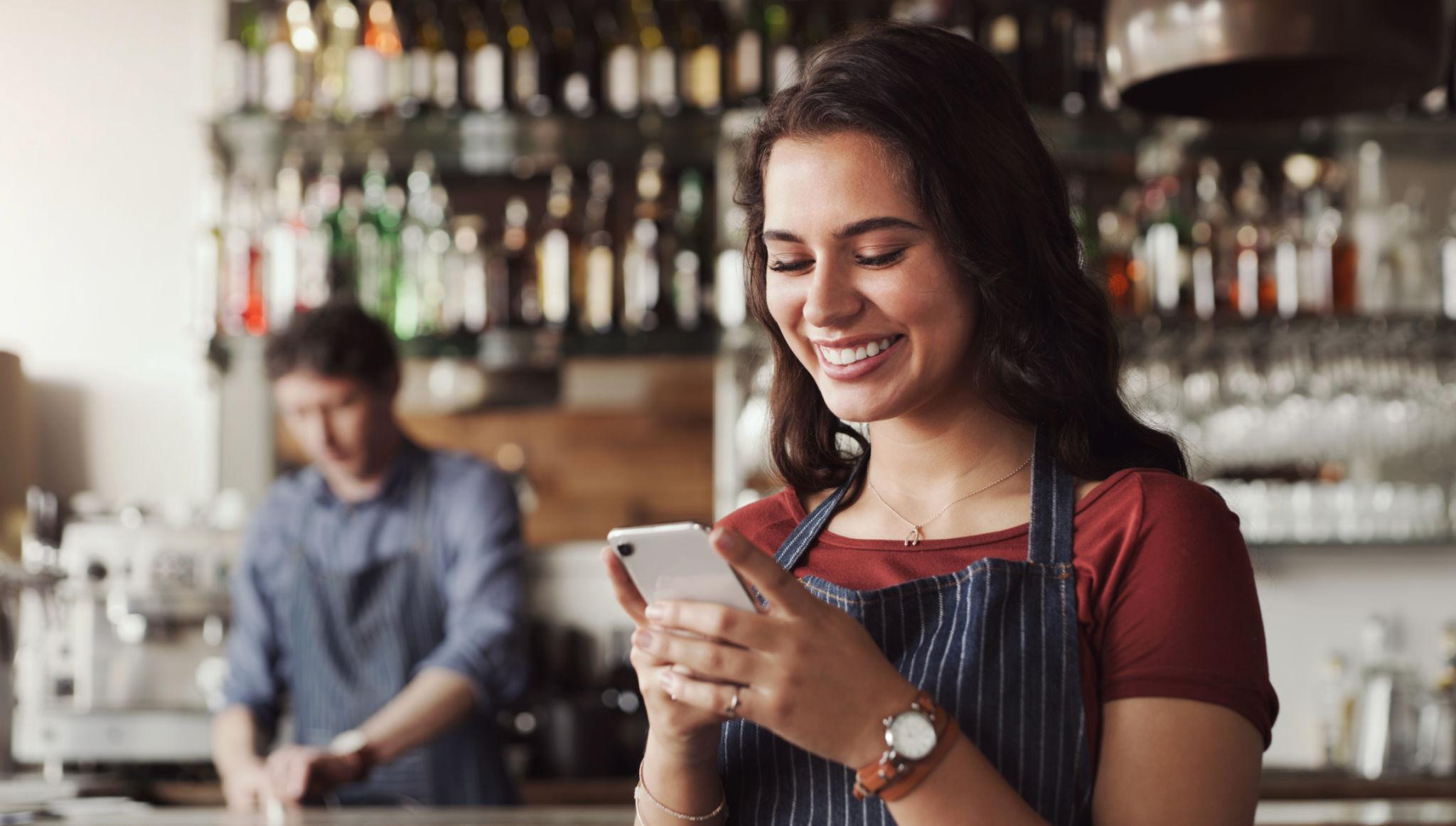 Hutto Texas business owner using mobile phone to engage with customers and improve local business growth